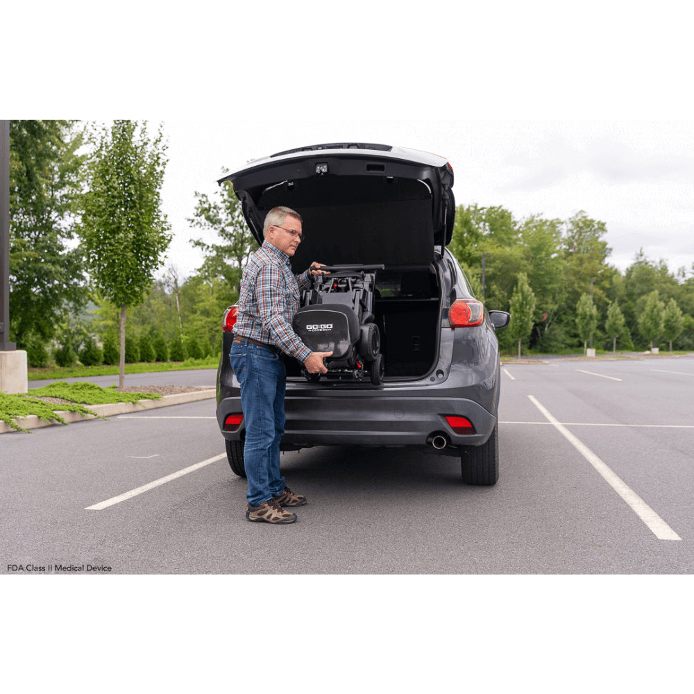 Pride Go Go® Carbon Quick Fold Scooter being carried to the back of the Car