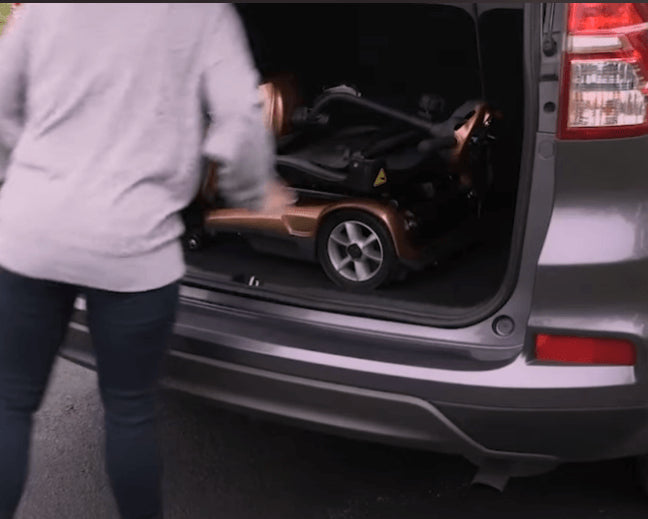 EV Rider Transport AF+ Automatic Folding Mobility Scooter at the back of a car
