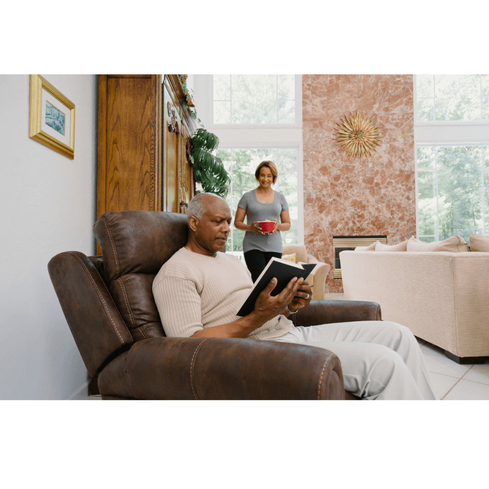 Elderly man reading a book while sitting in a Pride Mobility VivaLift Tranquil 2 PLR-935 Lift Chair
