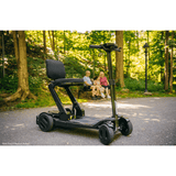 Pride Go Go® Carbon Quick Fold Scooter Close Lifestyle in the Woods