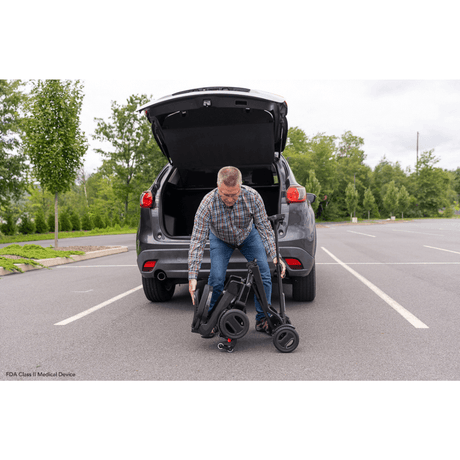 Pride Go Go® Carbon Quick Fold Scooter being carried to the back of the Car