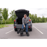 Pride Go Go® Carbon Quick Fold Scooter being carried to the back of the Car