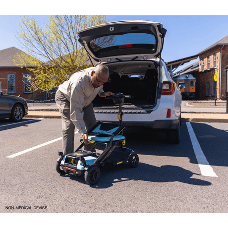 Mint Color  Pride Go Go® Super Portable Mobility Scooter being carried to the back of the Car
