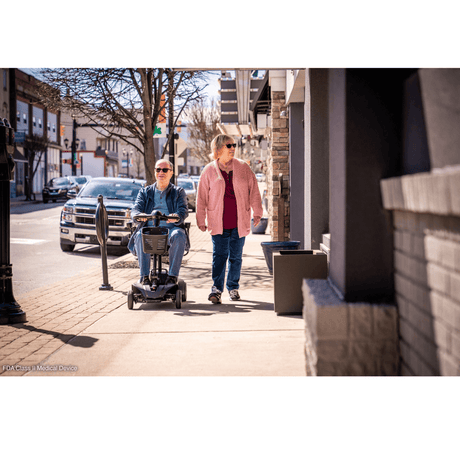 Pride Go Go Elite Traveller® 2 Mobility Scooter using in the walkway