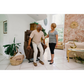 A woman helping an elderly man sit in a Pride Mobility VivaLift Tranquil 2 PLR-935 Lift Chair