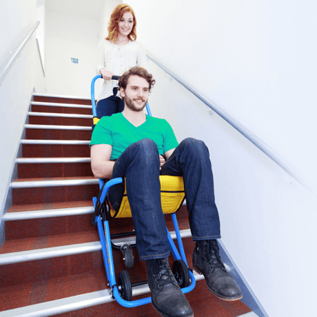 EVAC+CHAIR 300H Lightweight Emergency Stair Chair - Patient being safely assisted downstairs