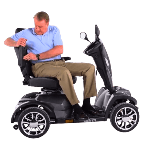 Man Adjusting Armrest of Drive Medical Cobra Gt4 Heavy Duty Power Mobility Scooter