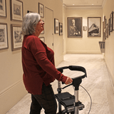 Triumph Mobility Escape Mini Compact Folding Rollator - Lady in an Art Gallery using the Rollator