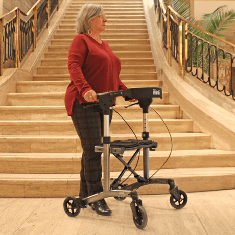 Triumph Mobility Escape Mini Compact Folding Rollator - Lady below the staircase using the Rollator